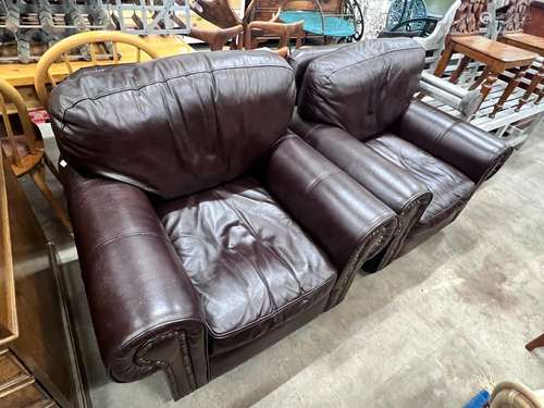 A pair of contemporary studded brown leather armchairs, widt...