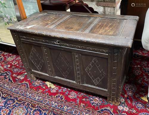 A 17th century carved panelled oak coffer, length 99cm, dept...