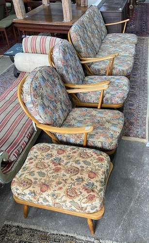 An Ercol beech three piece lounge suite and footstool, sette...