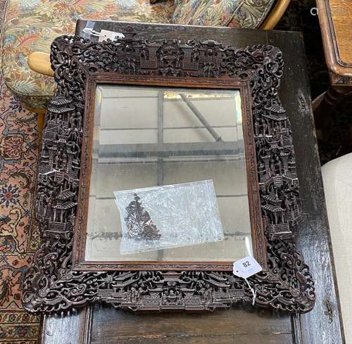 A Chinese rectangular carved hardwood wall mirror, width 52c...