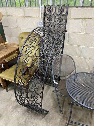 A black painted wrought iron scrollwork garden arch, width 1...