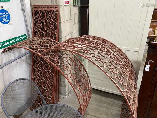 Three red painted wrought iron scrollwork garden arches, wid...