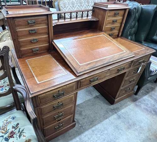 A late Victorian mahogany pedestal desk with hinged slant fr...