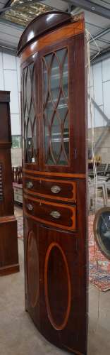 A large Regency mahogany bowfront standing corner cabinet, w...