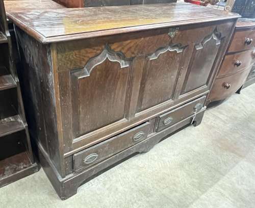 A mid 18th century oak mule chest with arched triple panelle...