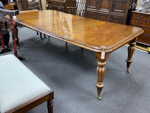 An early Victorian mahogany extending dining table on fluted...