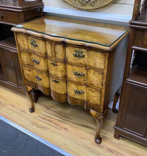 A Queen Anne revival burr walnut serpentine chest of drawers...