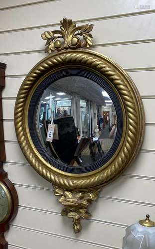 A Regency carved giltwood convex wall mirror, diameter 56cm,...