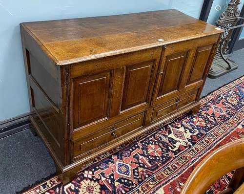 An 18th century panelled oak mule chest, initialled to the f...