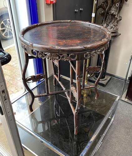 A Chinese circular hardwood tray top occasional table on fol...