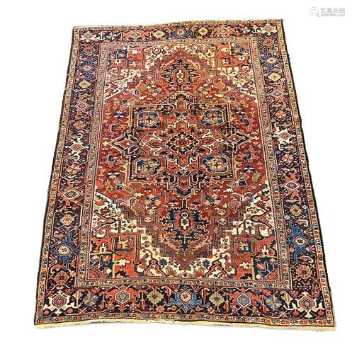 An Heriz red ground carpet, with a lobed central medallion w...