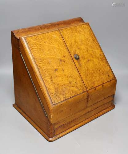 An oak two door stationary cabinet, 32 cms high,