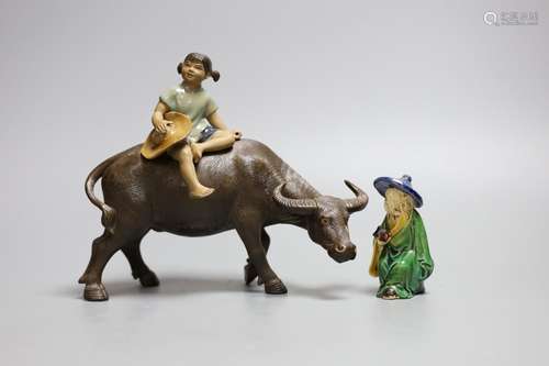 A Chinese Shiwan group of a girl on a buffalo and another,Gi...