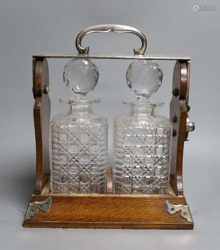 A Betjemann’s patent twin bottle oak and plated tantulus- no...