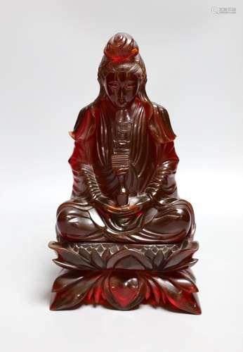 A Chinese ‘cherry amber’ phenolic seated figure of Guanyin, ...