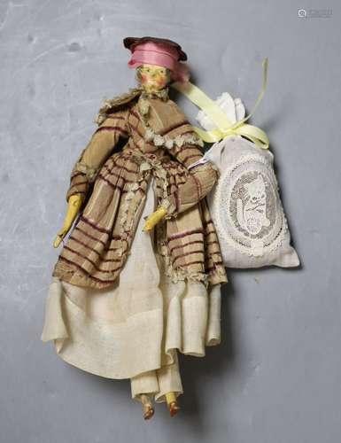 An early 19th century peg doll, wearing contemporary costume...