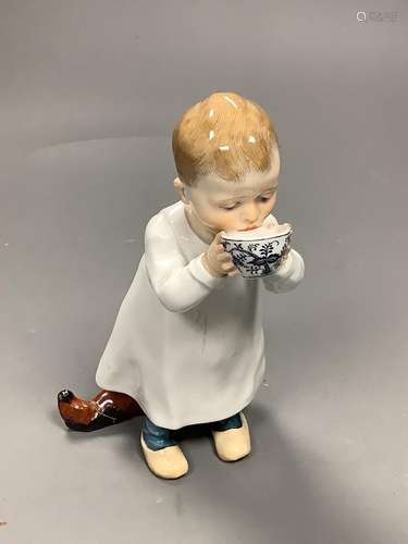 A Meissen figure of a child drinking from a bowl, modelled b...