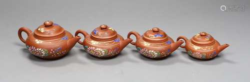 Four Chinese Yixing graduated enamelled miniature teapots,la...