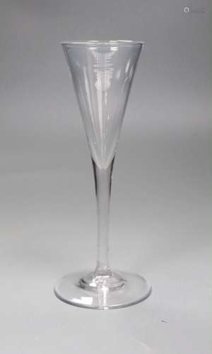 An 18th century toasting glass, 19cms high,