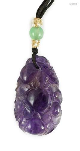 A Chinese amethyst pendant, 19th/20th century, carved in rel...