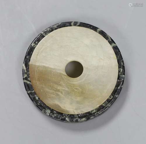 Two Chinese bi discs; in bowenite jade and black and green h...