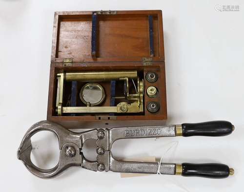 A mahogany cased microscope and a pair of Burdizzo tail dock...