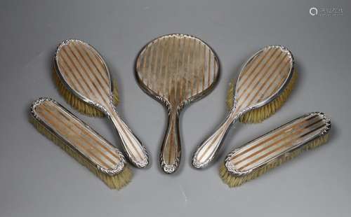 A George V silver and yellow metal five piece dressing table...