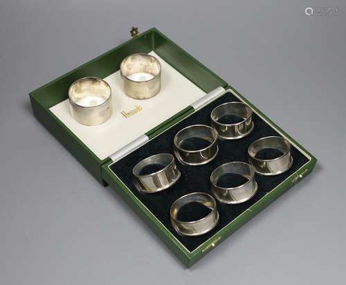 A cased set of six modern silver napkin rings and one other ...