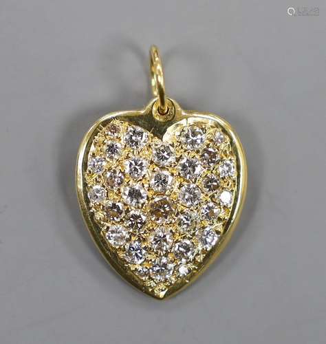 A modern 18ct gold and pave set diamond heart shaped pendant...