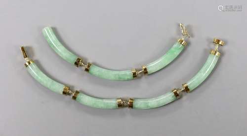 A modern Chinese 14k yellow metal and curved jade link brace...