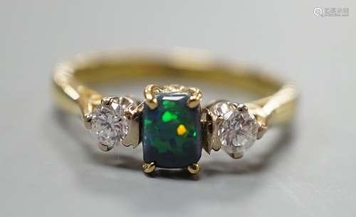 A modern 18ct gold, black opal and diamond set three stone r...