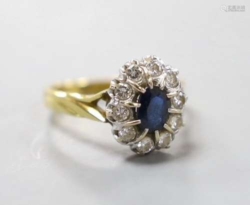 A modern 18ct gold, sapphire and diamond set oval cluster ri...