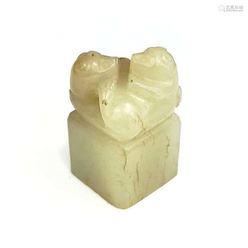 A Chinese carved pale jade and russet seal, Qing Dynasty.