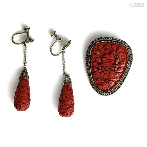 A Chinese cinnabar lacquer and white metal brooch and earrin...