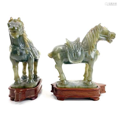 A pair of Chinese jade carved horses on wood stands.