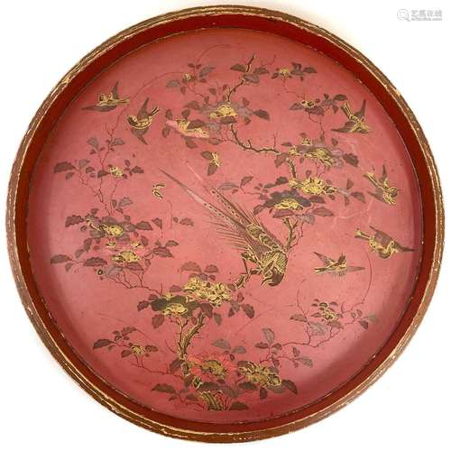 A large circular red lacquer tray.