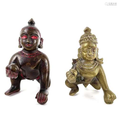 Two Tibetan bronze scroll weights,