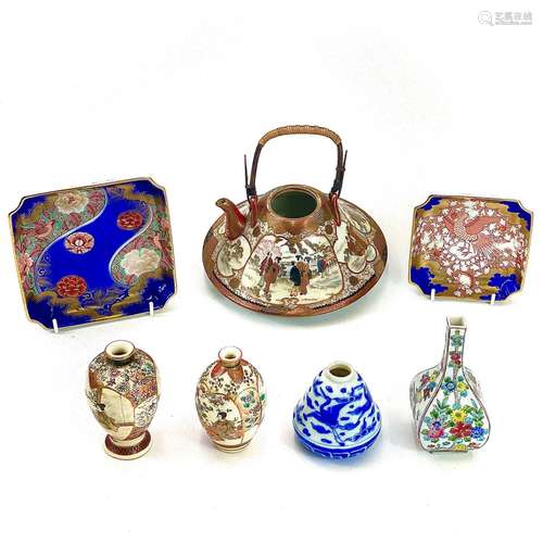 A Japanese porcelain Kutani teapot with cane handle decorate...