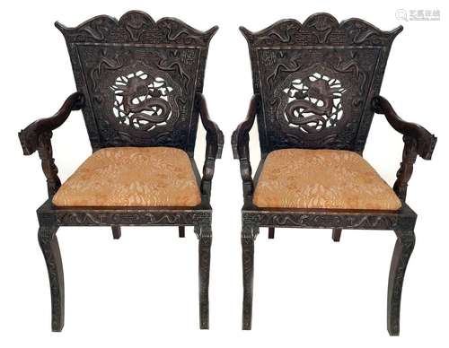 An impressive pair of Chinese carved hardwood armchairs, 19t...