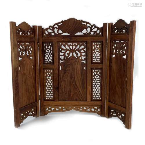 An Indian wood carved three fold table screen with brass mou...