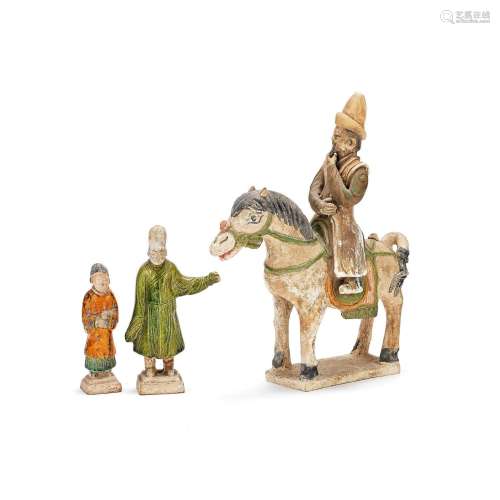 A POTTERY MODEL OF HORSE AND GROOM AND TWO ATTENDANTS Ming D...