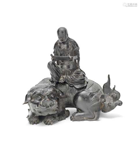 A BRONZE 'LUOHAN AND BUDDHIST LION' INCENSE BURNER M...