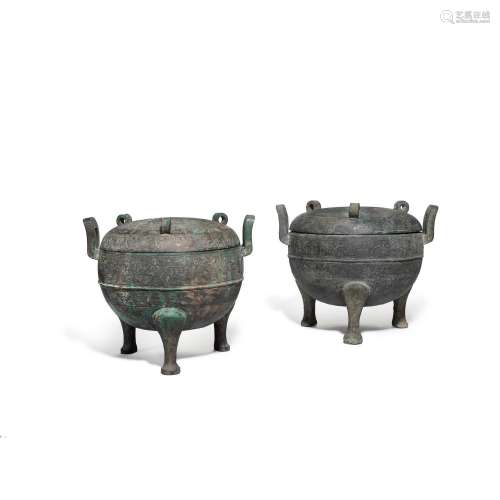 Two archaic bronze ritual tripod food vessels and covers, Di...
