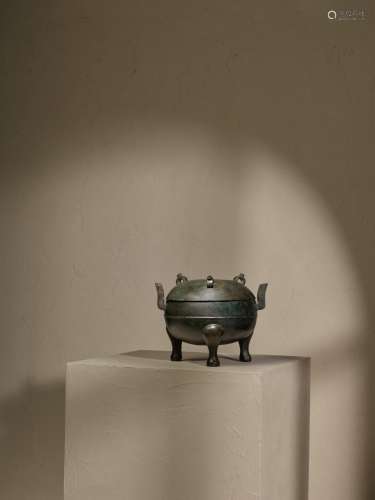 An archaic bronze tripod food vessel and cover, Ding, Han dy...