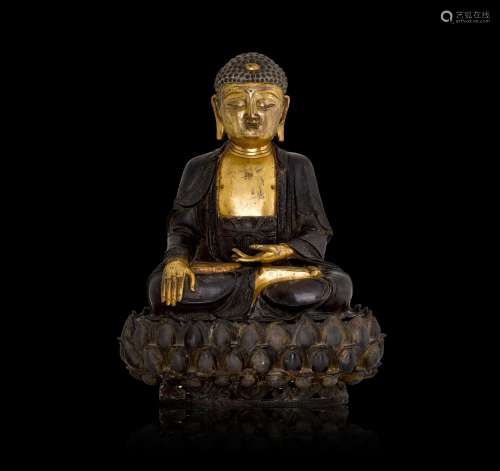 A large parcel-gilt bronze figure of Shakyamuni Buddha, Ming...