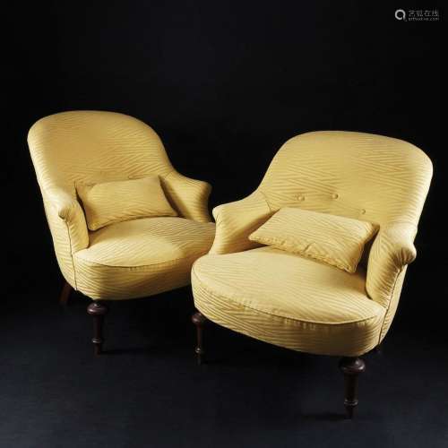 A pair of yellow fabric coated armchairs