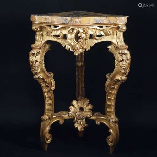 A carved gilt wood corner console with giallo di Siena plate...