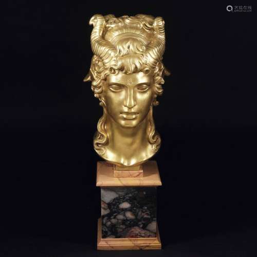 A gilt bronze head of a young satyr with a bucranium