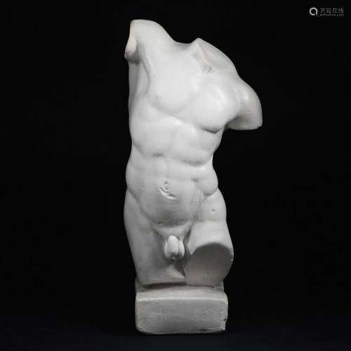 A plaster male torso after the antique
