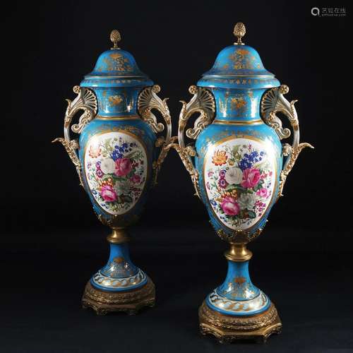 A pair of large ormolu mounted porcelain potiches and cover